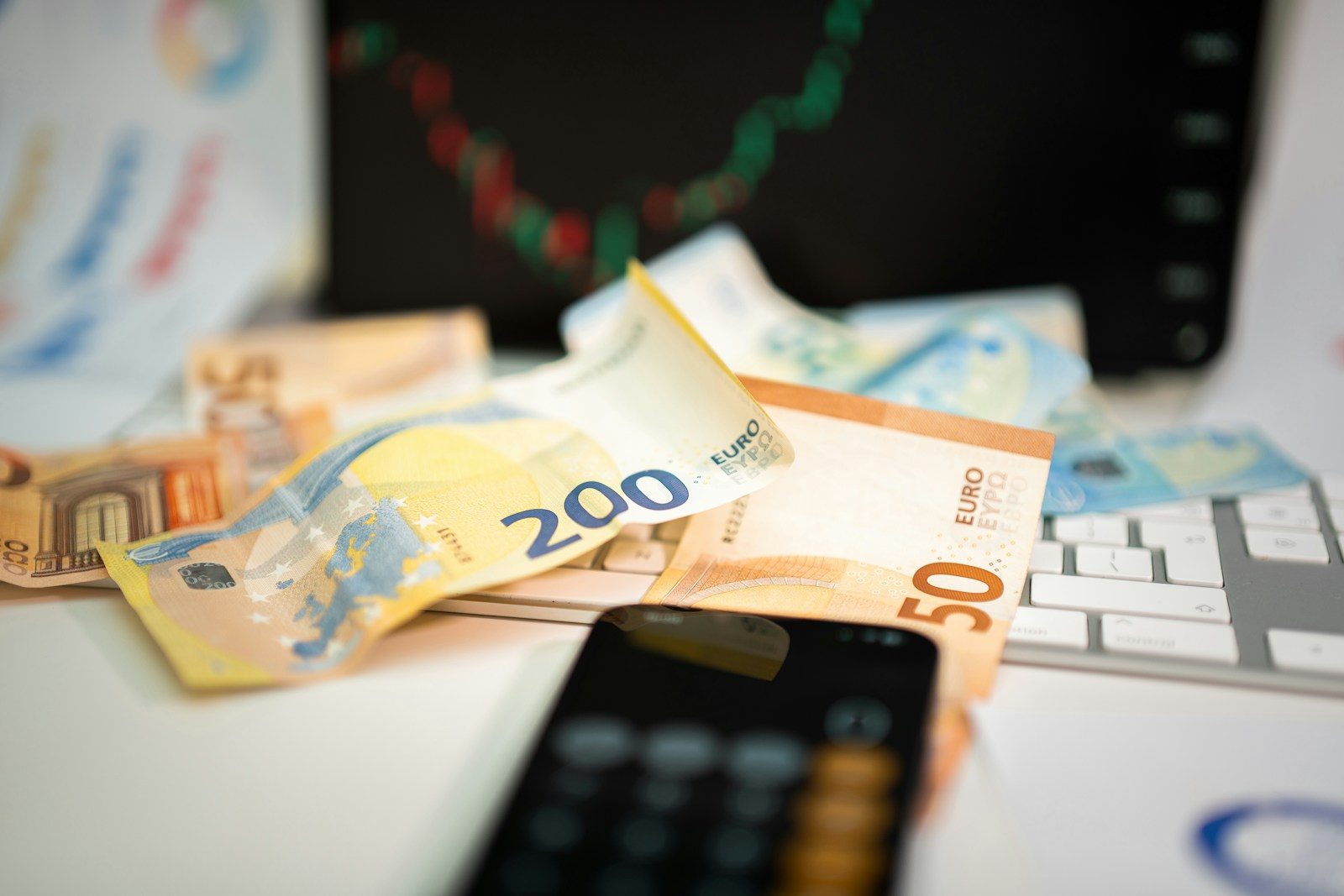 A mobile phone sitting on top of a pile of money
